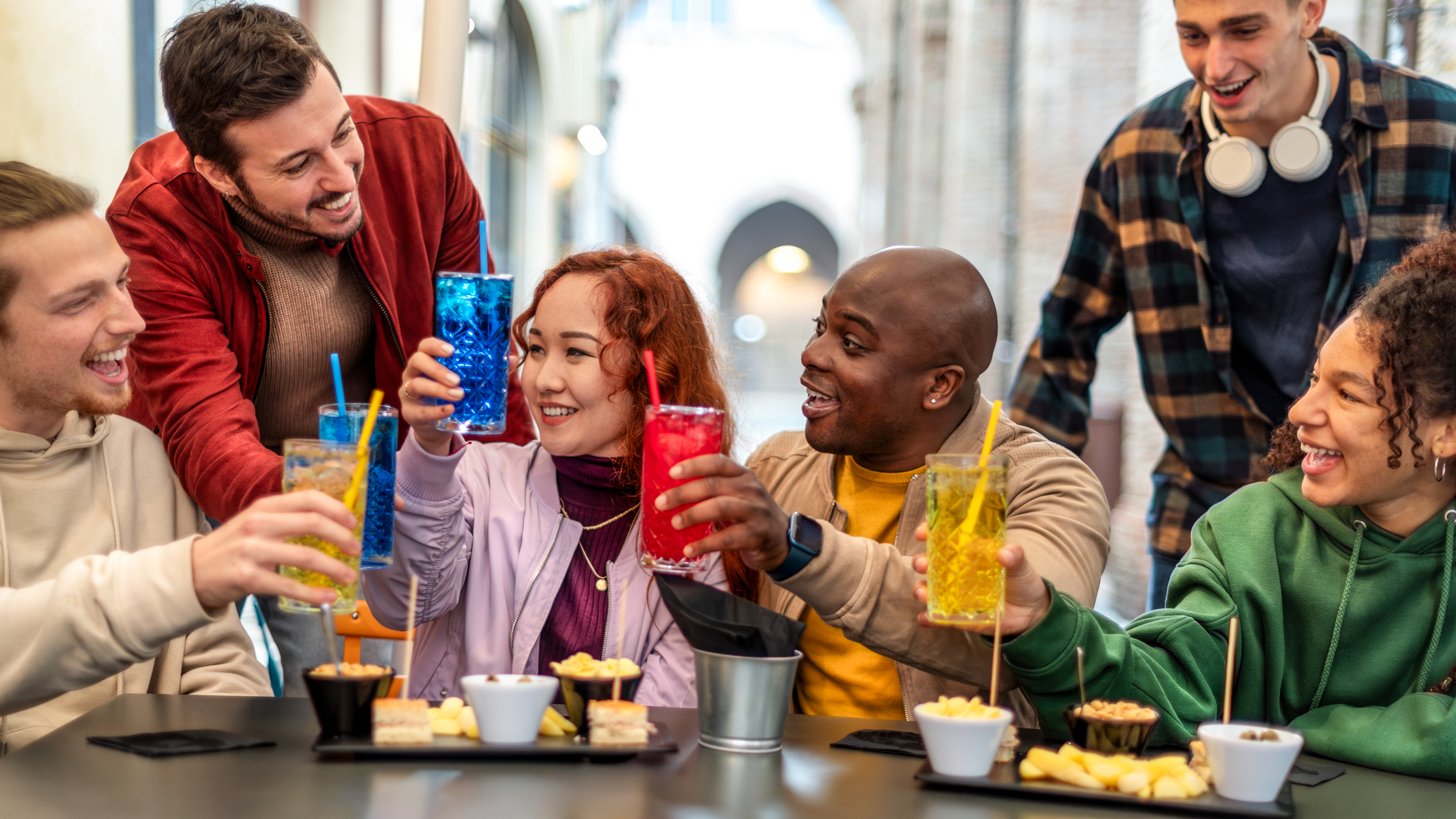 Young adults enjoying alcohol-free cocktails at happy hour